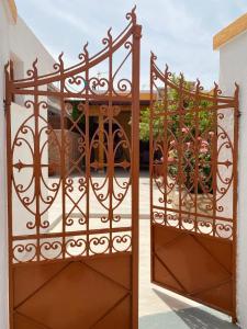 a gate to a patio with a garden at Archangelos House in Archangelos