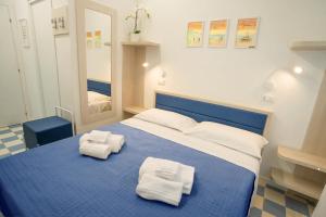 A bed or beds in a room at EDEN CONERO Camere Numana Centro