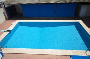 a large blue swimming pool next to a building at Golive Pepita in Cambrils