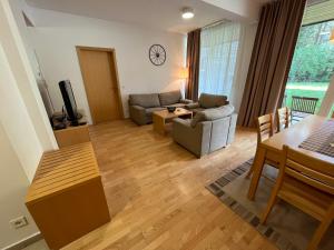 a living room with a couch and a table at Golden Fox Apartment Pohorje in Maribor