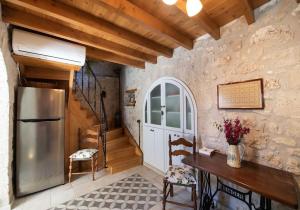 a kitchen with a refrigerator and a staircase at La casa di Bella a tradional stone house with barbecue in Kariá