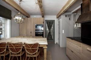 a kitchen with a large wooden table and chairs at Lilla Sand in Porvoo