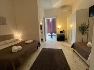 a bedroom with two beds and a living room at GL Sun Palace in Bari