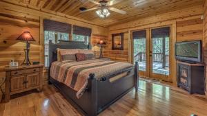 una camera da letto con un letto e una TV a schermo piatto di Tranquility a Blue Ridge