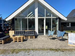 budynek z kanapami i krzesłami przed nim w obiekcie Viking Surf House w mieście Klitmøller