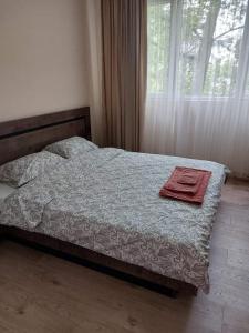 a bedroom with a bed with a towel on it at Sandanski city center apartment in Sandanski