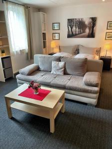 a living room with a couch and a coffee table at Rheinpromenade in Kamp-Bornhofen