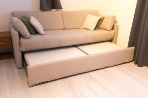 un sofá con almohadas en la sala de estar en Appartamento Speranza, en Molina di Ledro
