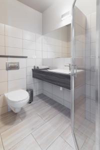 a bathroom with a toilet and a sink and a shower at Kamienica Mielno in Mielno +40 photos