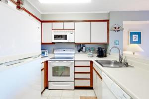 a kitchen with white cabinets and a sink at Hidden Harbour 312C in Ocean City