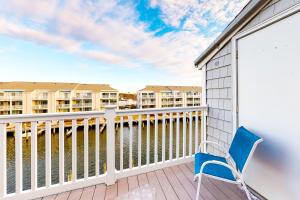 a blue chair on a balcony with condos at Hidden Harbour 312C in Ocean City