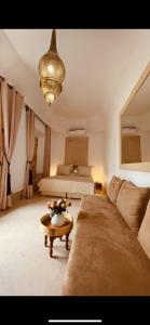 1 dormitorio con cama, sofá y mesa en Riad See Moon And Spa, en Marrakech