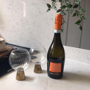 a bottle of wine and two wine glasses on a counter at Elizabeth Clark in Manningtree