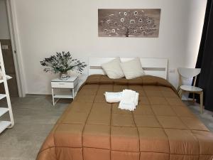 a bedroom with a large bed with two towels on it at Matty's in Olbia