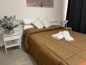 a bed with two towels on it in a bedroom at Matty's in Olbia +47 photos