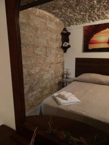 Un pat sau paturi într-o cameră la Casa Ciccio