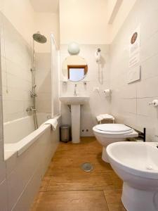 a white bathroom with a sink and a toilet at B&B Mazzini in Rome