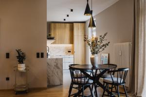 a kitchen and dining room with a table and chairs at meralino boutique apartment in Merano +13 photos