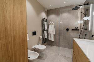 a bathroom with a toilet and a sink and a shower at meralino boutique apartment in Merano