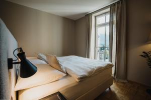 a bedroom with a bed with a window at meralino boutique apartment in Merano