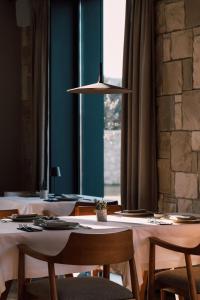 a dining room with tables and chairs and a light fixture at Teruar Urla in Urla +53 photos