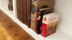 a row of books sitting on a shelf at Vivienda turistica con encanto centrico, wifi y patio in Bilbao