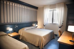 מיטה או מיטות בחדר ב-MH HOTEL VARAZZE