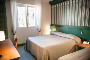 Postel nebo postele na pokoji v ubytování MH HOTEL VARAZZE