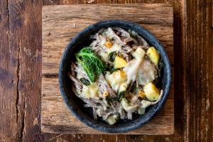 a bowl of food on a wooden cutting board at Agriturismo La Fiorida in Mantello