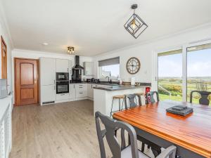 a kitchen and dining room with a table and chairs at Craigievar in Cruden Bay