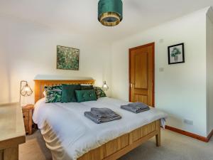 a bedroom with a bed with towels on it at Craigievar in Cruden Bay