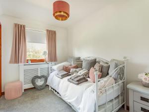 a childs bedroom with a white bed and a window at Craigievar in Cruden Bay