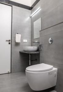 a bathroom with a white toilet and a sink at The Green Estate Resort in Nashik