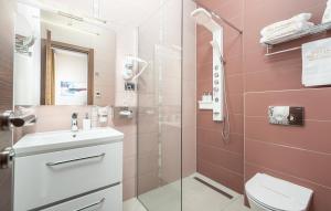 a bathroom with a shower and a toilet and a sink at Hotel Dua Residence in Poreč
