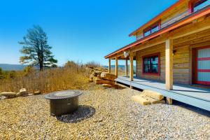 a log cabin with a picnic table in front of it at Rocky Mountain Way in Pagosa Springs