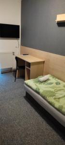Un pat sau paturi într-o cameră la Penzion KASPEC
