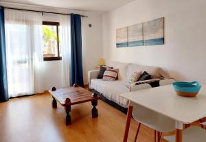 a living room with a couch and a table at Casa Ledù - Sunny Holiday in Fuerteventura in Corralejo