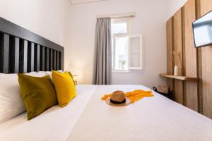 a bedroom with a bed with a hat on it at Casa Blue Sea View, Philian Collection in Skiathos Town
