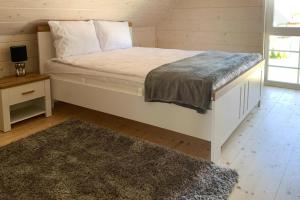 a bedroom with a large bed with a rug at Holiday VIP complex in Wartowo by Kolczewo for 6 persons in Kołczewo