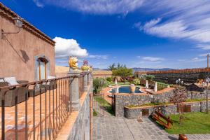 a villa with a swimming pool and a fence at Etna Quota Mille Boutique Hotel, Typical Sicilian Food & Wine in Randazzo