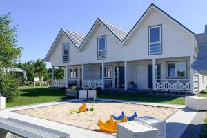 a house with a sand pit in front of it at Holiday VIP complex in Wartowo by Kolczewo for 6 persons in Kołczewo