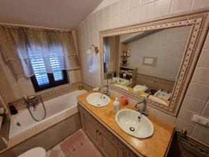 a bathroom with a sink and a tub and a mirror at CasAvelia in Scalea