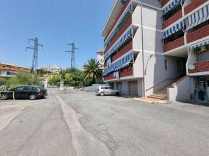 a parking lot with cars parked next to a building at CasAvelia in Scalea