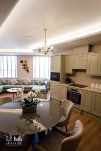 a kitchen and living room with a table and chairs at The Old Bank Apartments in Blackpool