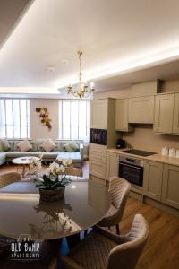 a kitchen and living room with a table and chairs at The Old Bank Apartments in Blackpool