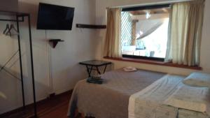 A bed or beds in a room at Tiny House