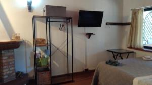 a room with a tv and a room with a bed at Tiny House in Cagliari