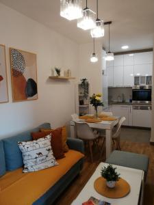 a living room with a couch and a table at Center Sunrise Apartment in Novi Sad
