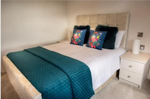 a bedroom with a bed with a green blanket on it at Ashwoods House in Enniskillen