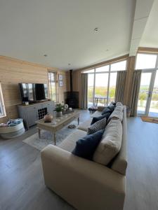 a living room with a couch and a table at 7 Piran View, Padstow in Padstow